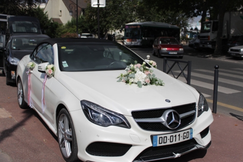 Voiture blanche avec fleurs sur le capot, rétroviseurs et portières